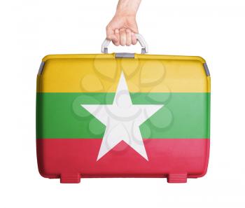 Used plastic suitcase with stains and scratches, printed with flag - Myanmar