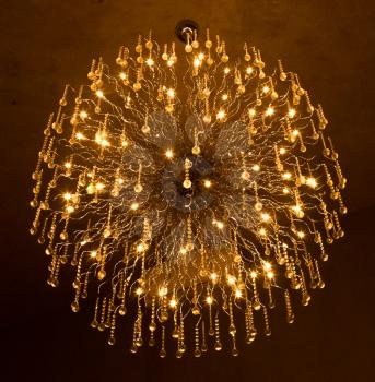 Large crystal chandelier providing light in the darkness