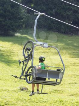 Ski lift chair in the Alps - Unrecognisable man in it - Austria