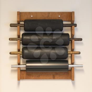 Collection of rolling pins hanging on a wall
