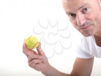 Tennis ball in hand, isolated on white background