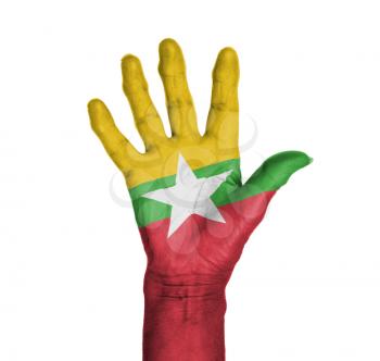 Palm of a woman hand, painted with flag of Myanmar