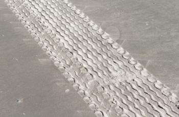 Tire tracks on the sand background, dutch beach