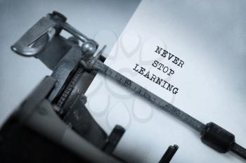Vintage inscription made by old typewriter, Never stop learning