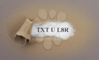 Text appearing behind torn brown envelop - Text you later