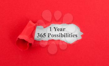 Text appearing behind torn red envelop - 1 Year, 365 possibilities