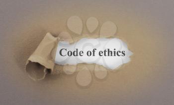 Text appearing behind torn brown envelop - Code of ethics