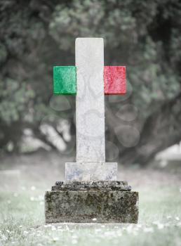 Old weathered gravestone in the cemetery - Italy