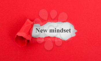 Text appearing behind torn red envelop - New mindset