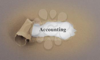 Text appearing behind torn brown envelop - Accounting,