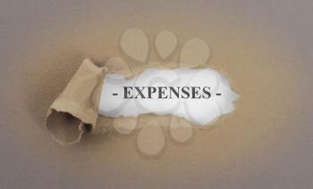 Text appearing behind torn brown envelop - Expenses
