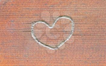 Heart carved in wood, old and worn