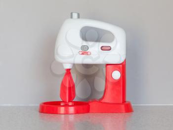 Toy cooking mixer or blender, isolated in the kitchen