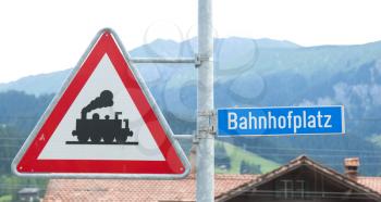 Train crossing sign in a village in Switzerland