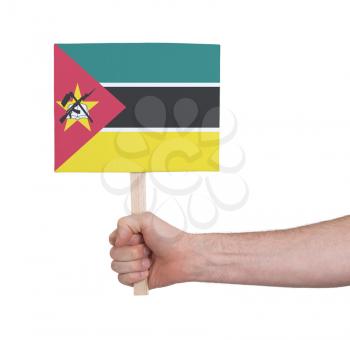 Hand holding small card, isolated on white - Flag of Mozambique