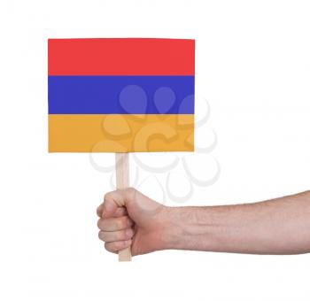 Hand holding small card, isolated on white - Flag of Armenia