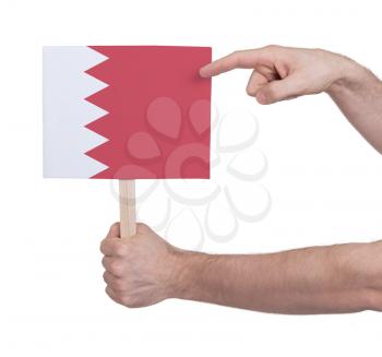 Hand holding small card, isolated on white - Flag of Bahrain