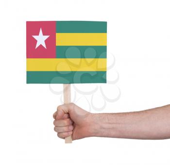Hand holding small card, isolated on white - Flag of Togo