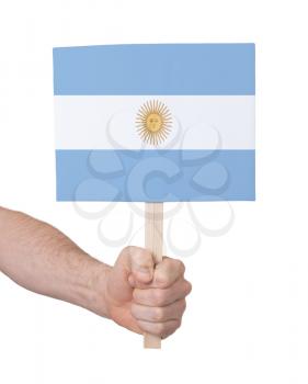 Hand holding small card, isolated on white - Flag of Argentina