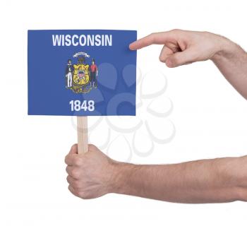 Hand holding small card, isolated on white - Flag of Wisconsin