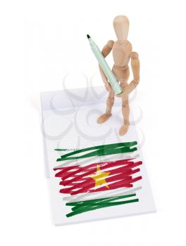 Wooden mannequin made a drawing of a flag - Suriname