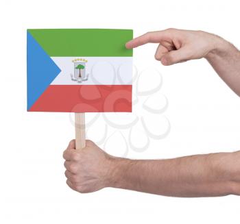 Hand holding small card, isolated on white - Flag of Equatorial Guinea