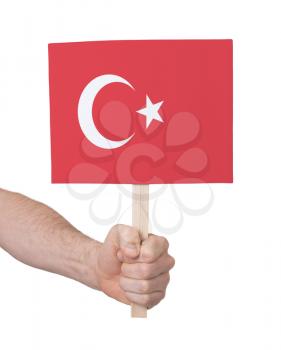 Hand holding small card, isolated on white - Flag of Turkey