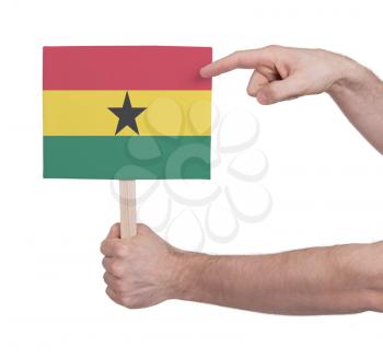 Hand holding small card, isolated on white - Flag of Ghana