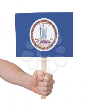 Hand holding small card, isolated on white - Flag of Virginia