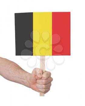 Hand holding small card, isolated on white - Flag of Belgium