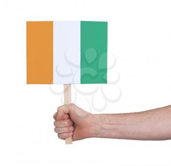 Hand holding small card, isolated on white - Flag of Ivory Coast