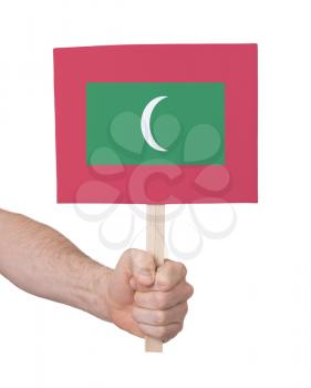 Hand holding small card, isolated on white - Flag of Maldives