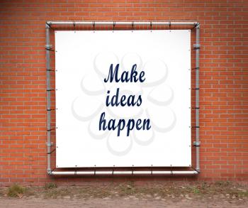 Large banner with inspirational quote on a brick wall - Make ideas happen