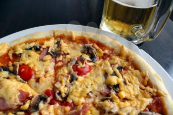 tasty appetizing pizza and glass of beer