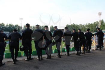 policemen standing guard over order in the stadium during football match