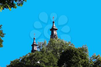 church's domes above the tree's crowns in Western Ukraine