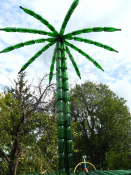 high palm tree made of bottles from a champagne