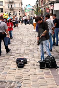 musician plays guitar in the central street of Lvov