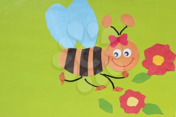 toy bee made by children's hands from colored paper