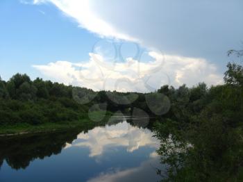 beautiful evening summer landscape with white clouds and river