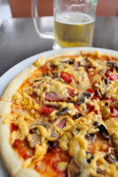 very tasty pizza with glass of cold beer