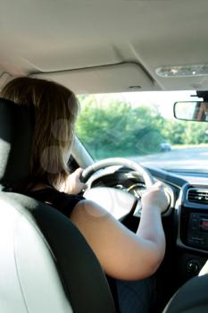 image of young woman driving the car