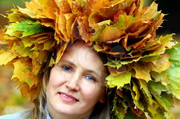 woman with yellow autumn leaves on the head