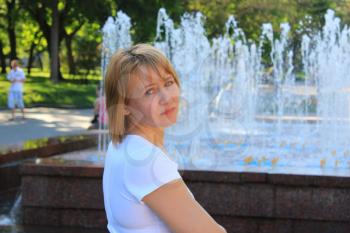 portrait of sympathetic young woman on the background of fountains