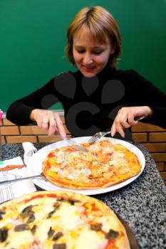 image of portrait of sympathetic young woman  in pizzeria