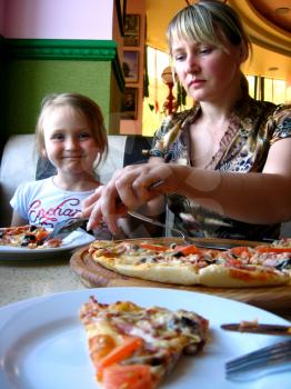 image of mother and daughter eating in pizzeria
