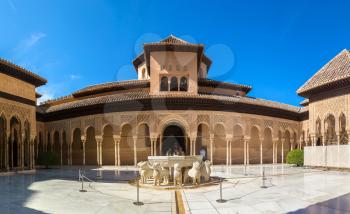The Court of the Lions in Alhambra palace in Granada in a beautiful summer day, Spain
