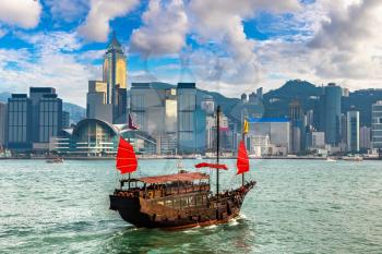 Traditional Chinese wooden sailing ship in Victoria Harbour in Hong Kong at summer day