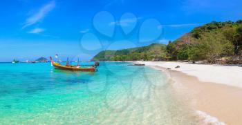 Panorama of Traditional long tail boat on Coral (Ko He) island near Phuket island, Thailand in a summer day