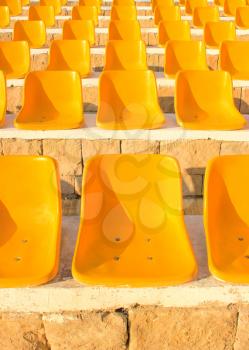Stadium Yellow Chairs at sun light.
